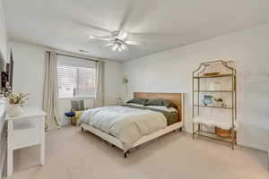 Bedroom with crown molding, carpet floors, and ceiling fan