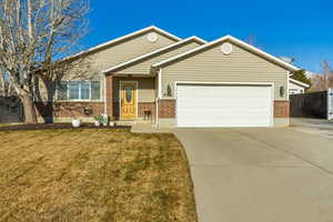 View of front of property with a garage and a front yard