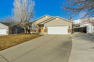 View of front of home featuring a garage and a front yard