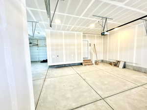 Garage with a garage door opener and EV charging outlet.