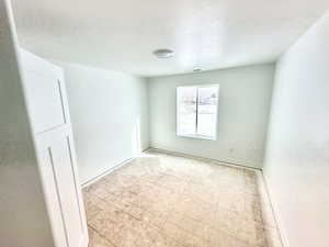 Secondary bedroom with carpeted flooring.