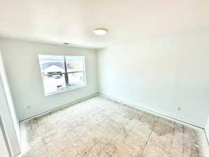 Secondary bedroom with carpeted flooring.