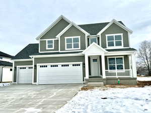 Craftsman-style house with three car garage and covered porch.