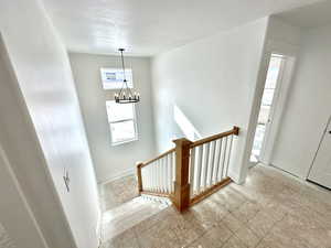 Stairway featuring stylish railing.