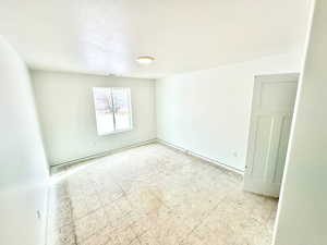 Secondary bedroom with carpeted flooring.