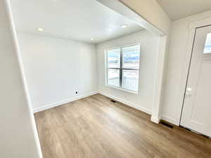 Entryway and home office/living room featuring light hardwood / wood-style flooring.