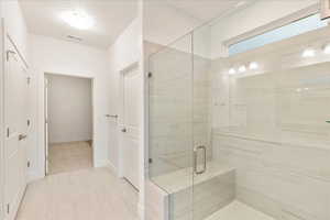 Primary bathroom with walk in shower and bench seat and Euro glass and double sinks