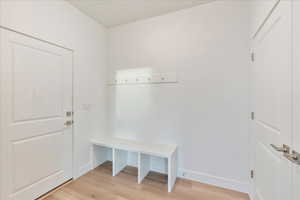 Mudroom with light hardwood / wood-style flooring