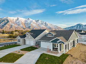 View of front facade with a garage and a mountain view