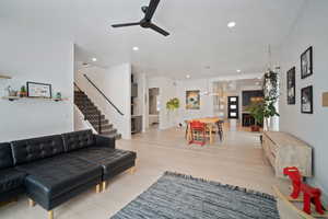 Living room featuring ceiling fan and light wood-type flooring