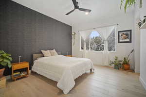 Bedroom with ceiling fan and light hardwood / wood-style floors