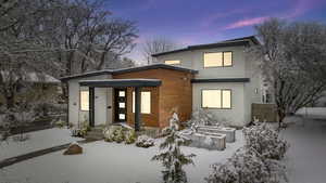 View of snow covered back of property