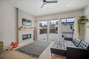 Living room featuring ceiling fan and light hardwood / wood-style floors