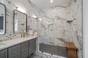 Bathroom featuring vanity and a tile shower