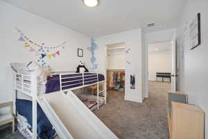 Bedroom featuring a closet, carpet floors, and a spacious closet