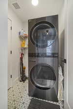 Laundry room with stacked washer and clothes dryer