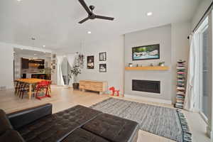 Living room featuring hardwood / wood-style floors and ceiling fan