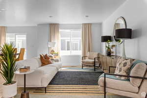 Living room with hardwood / wood-style floors and a textured ceiling