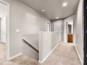 Hallway with light colored carpet