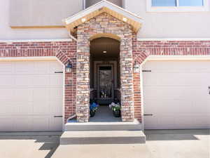 Doorway to property with a garage