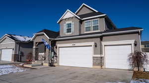 View of front of home with a garage and solar panels