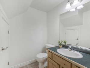 Bathroom featuring tile patterned flooring, vanity, and toilet