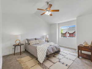 Bedroom featuring lofted ceiling, light carpet, and ceiling fan