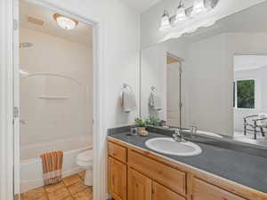 Full bathroom featuring vanity, shower / bathtub combination, and toilet