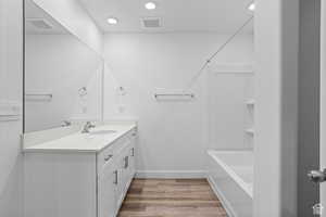 Bathroom featuring wood-type flooring and vanity