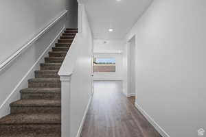 Staircase with hardwood / wood-style floors