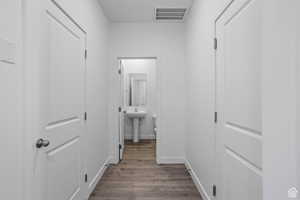 Hallway featuring sink and hardwood / wood-style floors