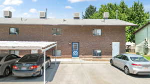 Rear view of property featuring central air condition unit