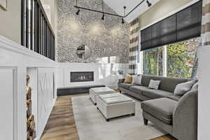 Living room featuring a towering ceiling and light hardwood / wood-style flooring