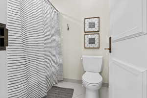 Bathroom with tile patterned floors and toilet