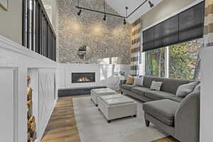 Living room featuring a towering ceiling and light wood-type flooring