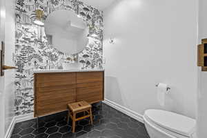 Bathroom with tile patterned flooring, vanity, and toilet