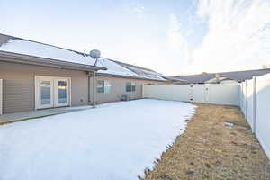 Yard layered in snow with central AC unit