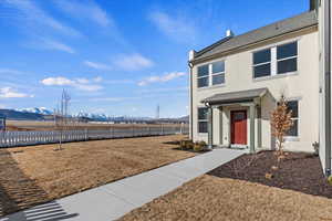 Exterior space with a mountain view and a front lawn