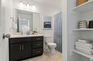 Bathroom featuring vanity, tile patterned floors, and toilet