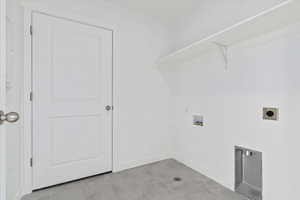 Laundry room with hookup for a washing machine, hookup for an electric dryer, and light tile patterned flooring