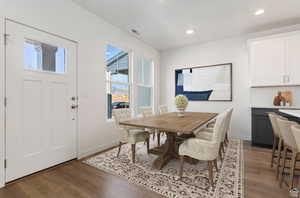 Dining space featuring dark wood-type flooring