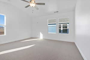 Carpeted spare room with lofted ceiling and ceiling fan