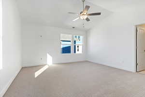 Unfurnished room with lofted ceiling, light colored carpet, and ceiling fan