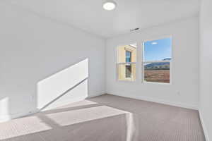 Unfurnished bedroom featuring light colored carpet