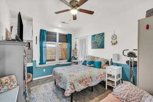 Bedroom with dark hardwood / wood-style flooring and ceiling fan