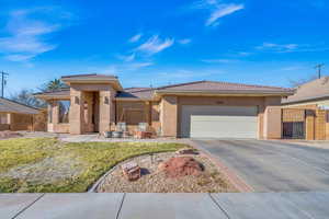 View of front of home featuring a garage and a front yard