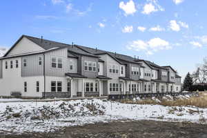 View of snow covered back of property