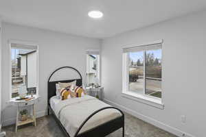 Bedroom featuring dark colored carpet