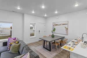 Dining space with a wealth of natural light and light wood-type flooring