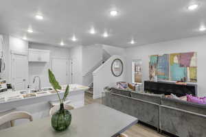 Living room featuring sink and light hardwood / wood-style floors